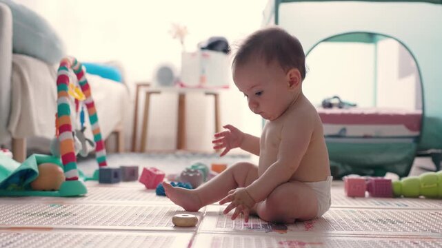 Adorable baby playing with educational toys in a nursery
