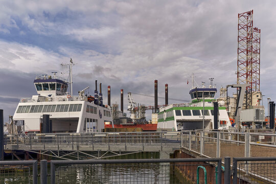 Esbjerg, Syddanmark, Denmark - 26 July 2026: View of Fanolinjen ferries Menja and Grotte docked at the harbor, with the electric Grotte discharging vehicles and industrial structures.