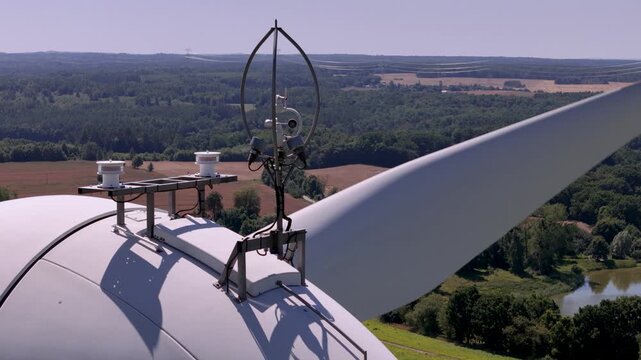 Close-up of wind turbine anemometer and meteorological sensors on nacelle roof for renewable energy and green technology