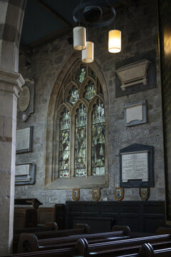 York, United Kingdom - 14 July 2026: View of the interior of a historic church in York featuring stained glass windows, stone walls, and wooden pews.