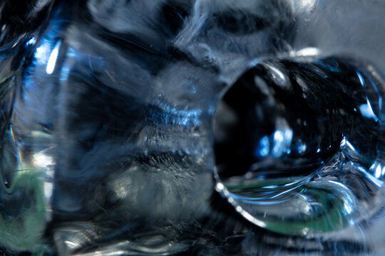 Under macro closeup, the ice reveals abstract patterns and textures against a cold background. Ice Cracked crystal formations, born from frost and water, create a transparent and beautiful design