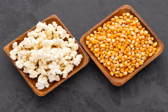 Comparison between popping corn and ready-to-eat popcorn, with minimalist composition and space for text in stock photography.