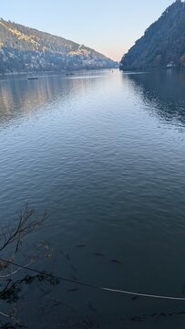 the serene, pear-shaped Naini Lake in the popular Himalayan resort town of Nainital, Uttarakhand, India. It is a lush mountain valley nestled in the Kumaon forest-clad foothills of Himalayas. 