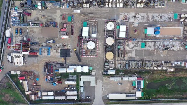 Aerial View of Land Drilling Rig and Oilfield Facility in Rice Fields