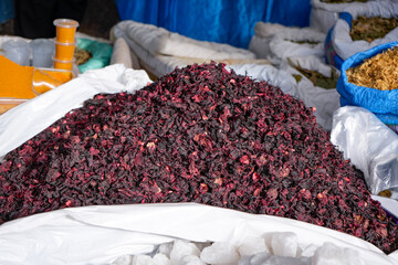 Pile of Deep Red Dried Hibiscus Flowers for Sale at a Market Stall © WILL PHOTOGRAPHY