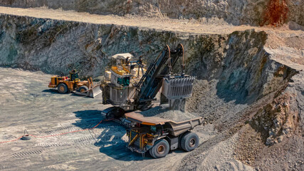 Hydraulic Excavator Loading Ore into a CAEX Haul Truck inside an Open Pit Mine © WILL PHOTOGRAPHY