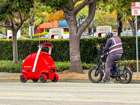 DoorDash Autonomous Delivery Robot on City Street with Human Operator
