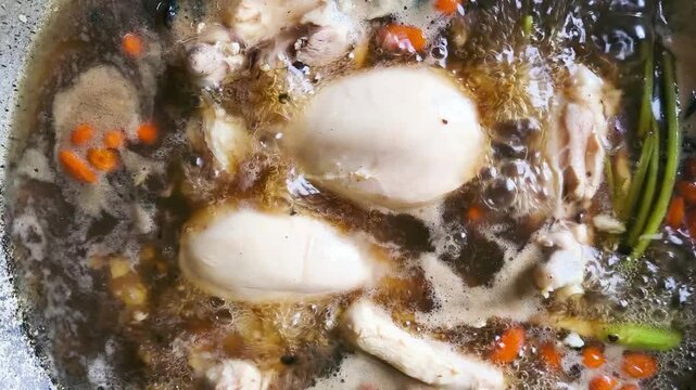 Cooking chicken soup with winter melon in pot, indoor Chiangmai Thailand.