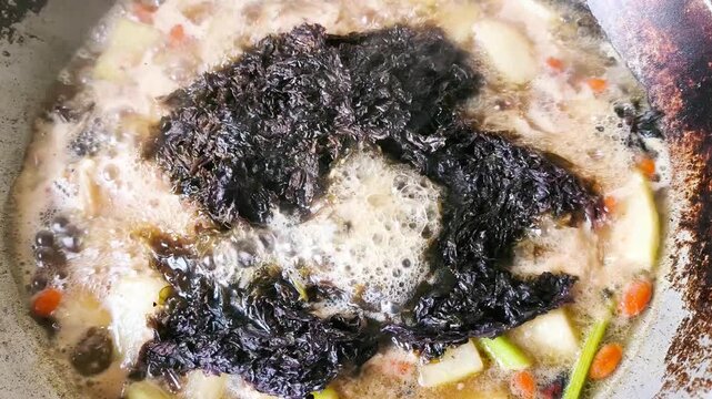 Cooking chicken soup with winter melon in pot, indoor Chiangmai Thailand.