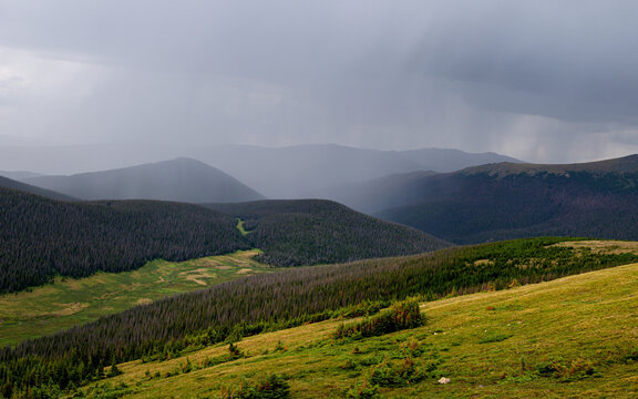 A heavy rainstorm is falling over Mountain range at Rocky Mountain National Park, Colorado