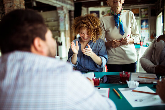 Happy coworkers brainstorming at creative workshop table