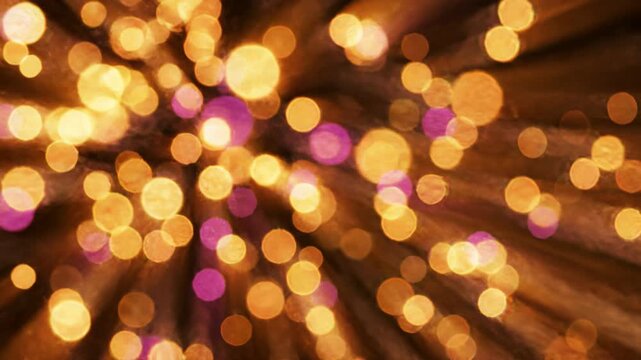 Golden bokeh firework particles exploding in the bottom corner over a solid black background for festive celebrations.