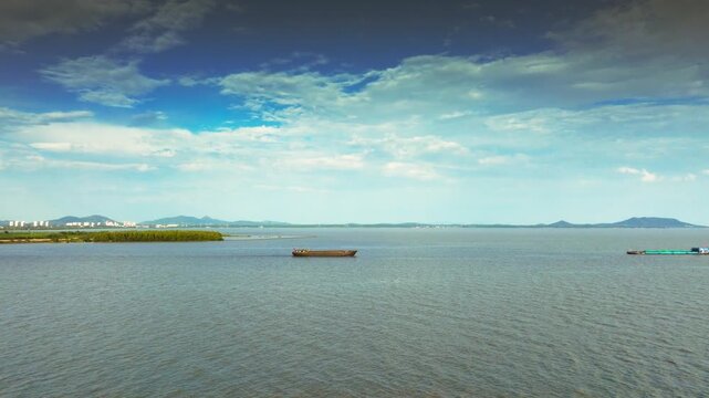 Hefei Chaohu Aerial: Cargo Boat Glides on Azure Waters, Distant Hills Mirror Blue Sky