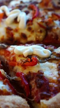 Fresh delicious pizza being sliced and served in a restaurant