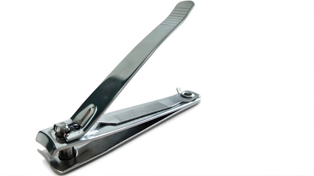 Close-up shot of a metallic silver nail clipper isolated on a solid white background with copy space, used for personal hygiene and manicure.