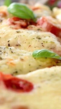 Close-up of freshly baked artisan pizza with melted cheese and basil