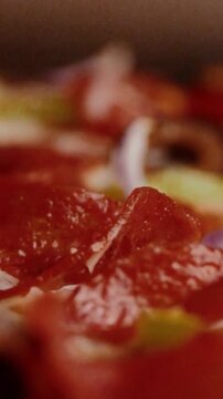 Close-up macro shot of fresh pepperoni pizza with red onions