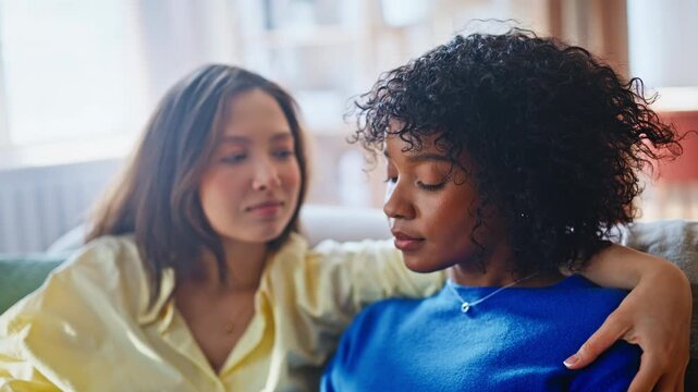 Female couple comforting home. Girlfriend kissing forehead, tender care support.