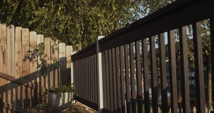 Wooden deck railing and privacy fence in a suburban residential backyard. Louisiana.