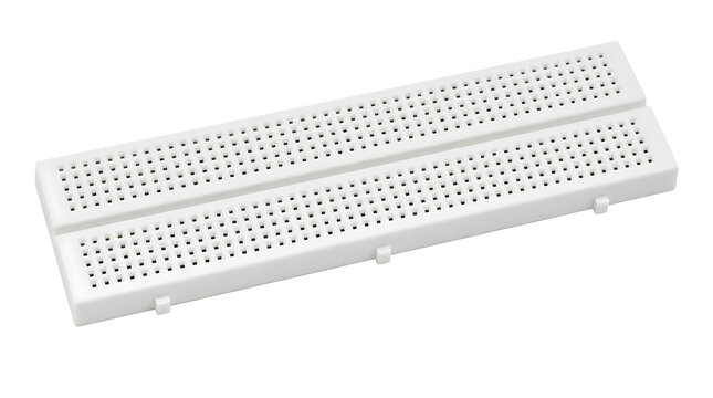 White breadboard with multiple holes for electronics prototyping.