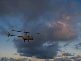 Robinson R44 Helicopter Into The Sunset. © david hutchinson