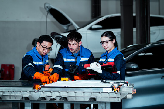Team of automotive technicians collaborating during vehicle inspection and maintenance in a professional repair workshop, teamwork, mechanical expertise, automotive diagnostics and technical service.