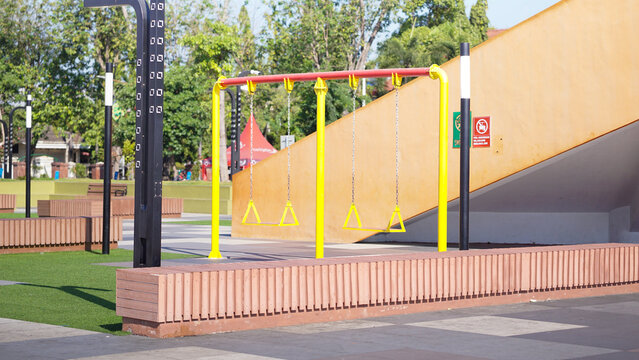 Empty Children Playground Area in City Square Park Under Clear Blue Sky