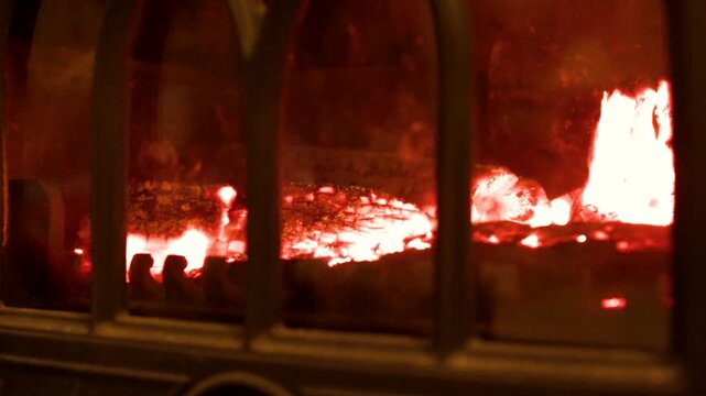 Burning Logs and Glowing Embers in a Cast Iron Wood Stove