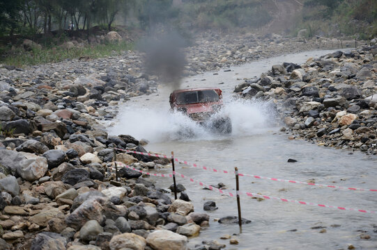Autocross Racing Vehicle Splashing Through River Course