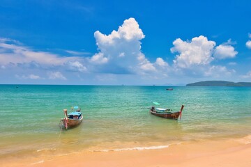 Obraz premiumThailand - Krabi - Ao Nang Beach July 22nd 2026. This was on a beautiful morning during the wet season. The Andaman sea during the low season surrounded by beautiful mountains.