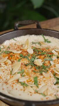 Traditional kofta meatballs cooking in a frying pan.