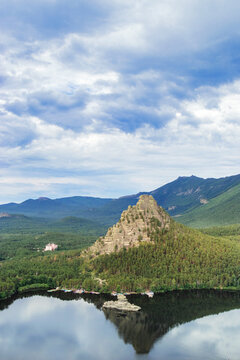 Burabay Borovoe Lake, mountain Okzhetpes, rock Zhumbaktas, top view from mount peak Bolektay, cloud blue sky and green forest. Burabay National Nature Park in Kazakhstan. Popular travel destination.