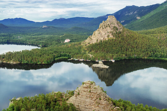 Burabay Borovoe Lake, mountain Okzhetpes, rock Zhumbaktas, top view from mount peak Bolektay, cloud blue sky and green forest. Burabay National Nature Park in Kazakhstan. Popular travel destination.