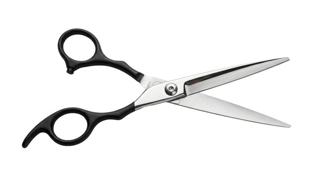 Professional hair cutting scissors with black handles isolated on a solid black background for salon use