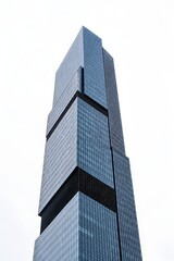 Fototapeta premium Isolated Modern Skyscraper Set Against Plain White Overcast Sky Highlighting Simple Geometry And Commercial Composition