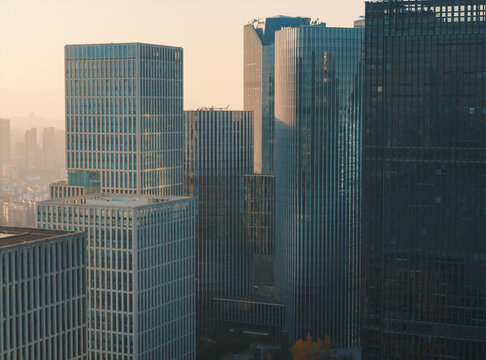Downtown buildings and skyscrapers in Hangzhou at early evening, sunlight reflecting off windows, showing modern architecture