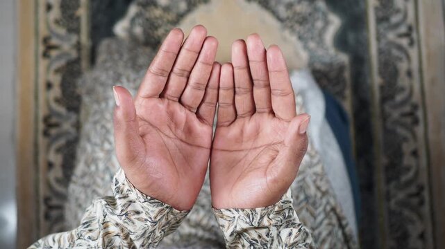 Muslim man Hands raised in prayer during a moment of reflection