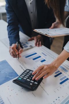 Business professionals analyzing financial data and calculating reports