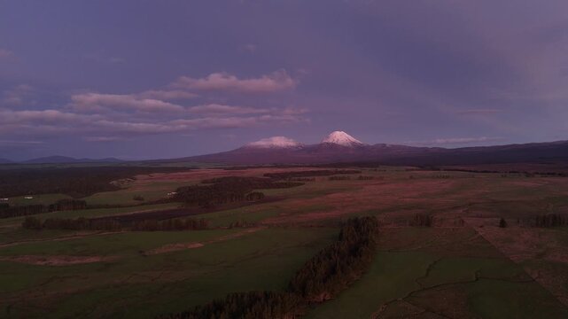 Stunning 4K 60fps drone footage of Mount Ruapehu and the Tongariro Alpine Crossing at dusk. This aerial view captures the majestic purple sky over the famous Lord of the Rings filming location in NZ