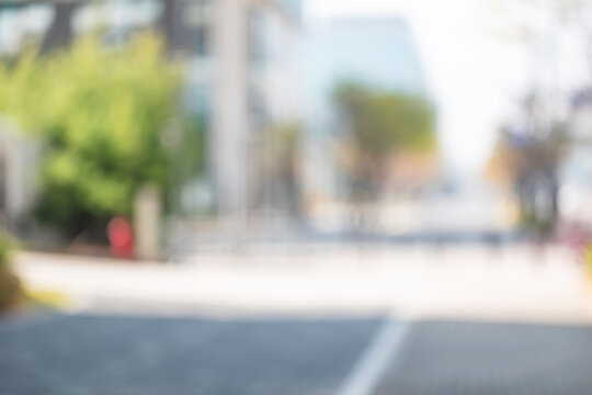Abstract blurred background of modern city plaza with green trees
