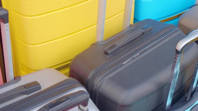 Group of colorful hard shell suitcases standing together at airport terminal travel concept