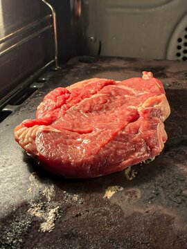 Raw Fresh Red Beef Steak on Oven Grill Cooking Preparation Close Up