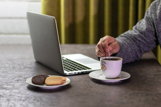 Taking a sweet break: stirring hot chocolate during a remote work session