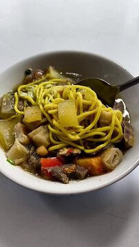Traditional Soto Mie Bogor Being Stirred with Spoon, Indonesian Street Food Vertical Video