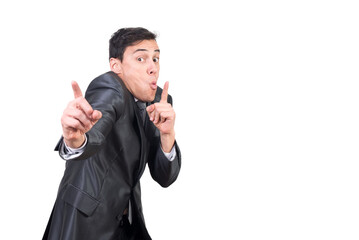 Fototapeta premium Man in elegant suit pointing up and looking at camera with funny face expression