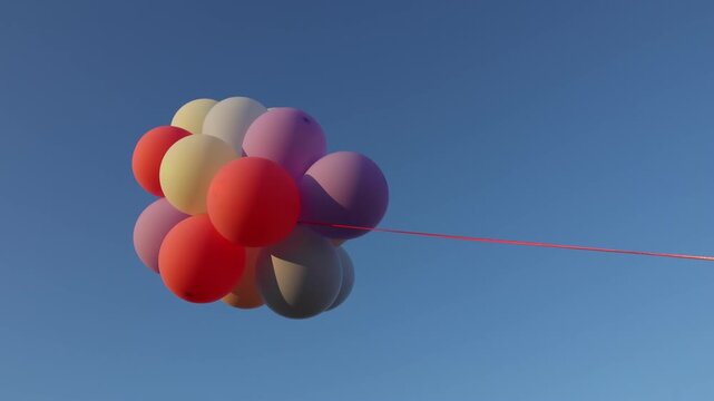 A bunch of colorful helium balloons against a blue sky