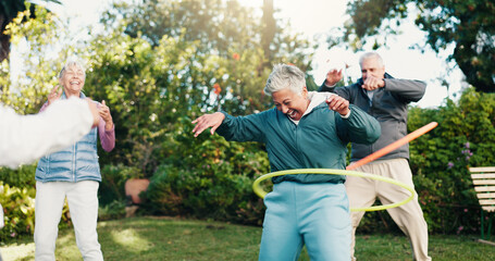 Smile, elderly people and hoop in park for fitness, body mobility and outdoor for wellness. Happy, senior group and plastic ring toy for core training, warm up exercise or retirement health in nature © peopleimages.com