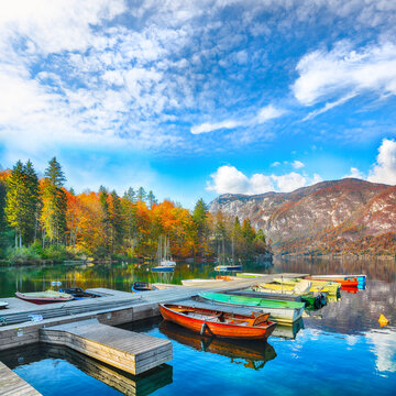 Remarkable view  of  Bohinj Lake with boats during autumn.
