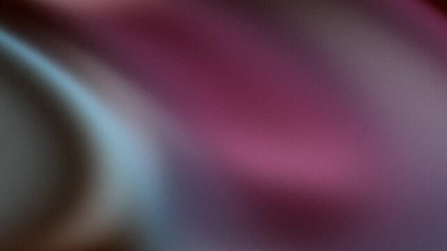 Abstract grainy background with moody brown and magenta color gradient.