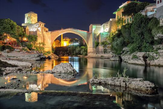 Amazing evening view of Mostar with the Mostar Bridge, houses and minarets, at evening.